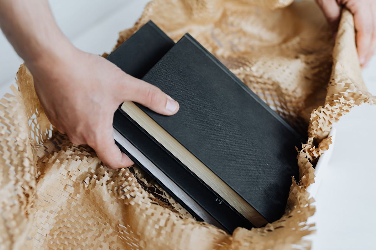 Notebooks being packed in honeycomb kraft paper